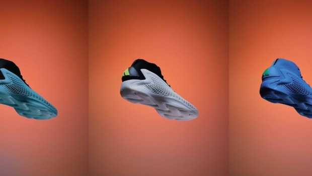 Side view of three of Anthony Edwards' multicolor adidas sneakers.
